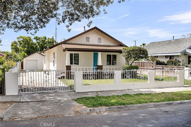 970 E 6th St, Pomona, CA 91766 - view of front of house with stucco siding, a fenced front yard, concrete driveway, and a porch