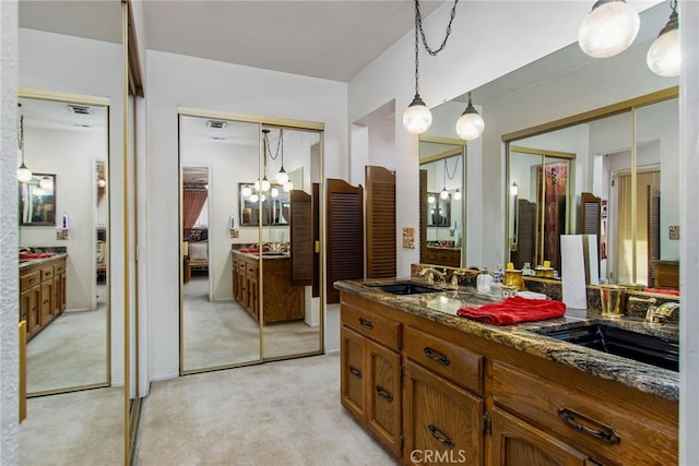 bathroom featuring vanity and a chandelier