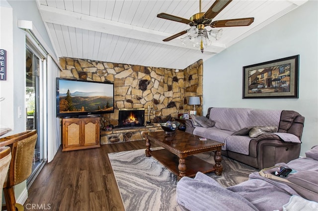living area featuring wood ceiling, dark wood-type flooring, a ceiling fan, and a stone fireplace