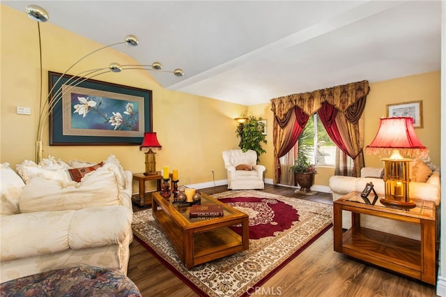 living room with wood finished floors, baseboards, and vaulted ceiling