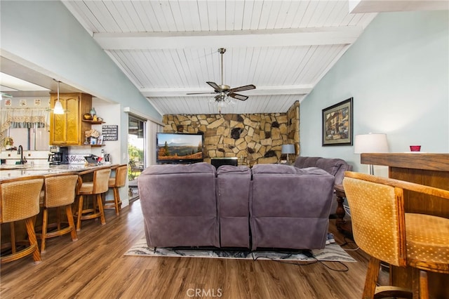 living area with wood finished floors, a ceiling fan, and wood ceiling