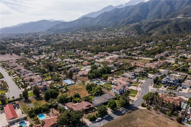 aerial view of property's location with mountains and nearby suburban area