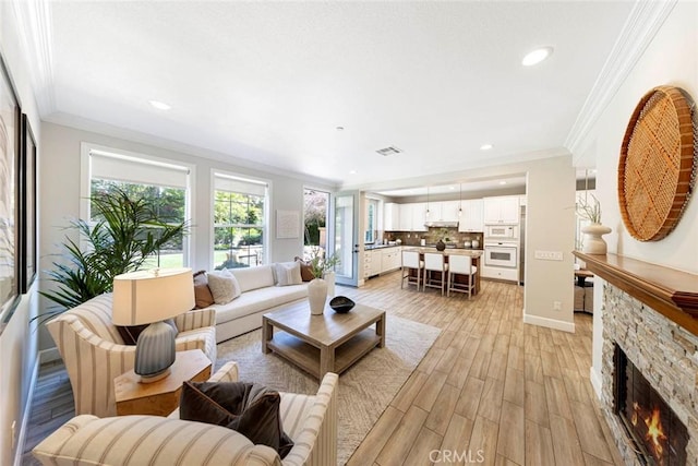 107 Plaza Via Sol, San Clemente, CA 92673 - living room featuring ornamental molding, recessed lighting, light wood-type flooring, a stone fireplace, and baseboards