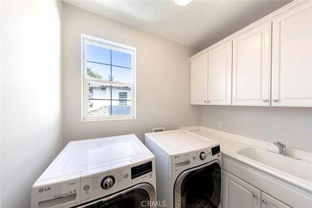107 Plaza Via Sol, San Clemente, CA 92673 - laundry area featuring cabinet space and washing machine and clothes dryer