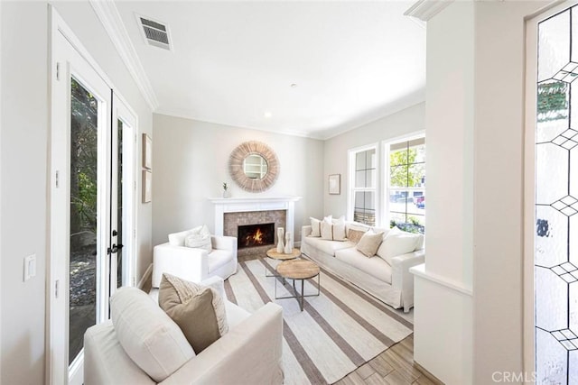 107 Plaza Via Sol, San Clemente, CA 92673 - living area with light wood-style floors, ornamental molding, and a warm lit fireplace