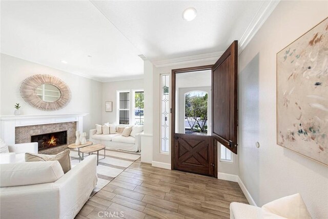 107 Plaza Via Sol, San Clemente, CA 92673 - foyer with light wood-type flooring, crown molding, baseboards, and a high end fireplace