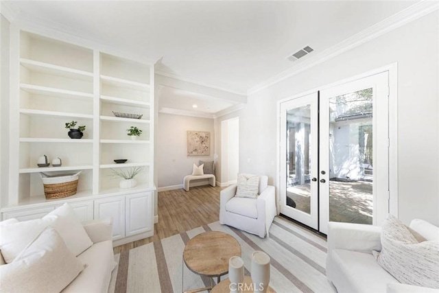 107 Plaza Via Sol, San Clemente, CA 92673 - living area featuring crown molding, french doors, light wood-type flooring, baseboards, and built in shelves