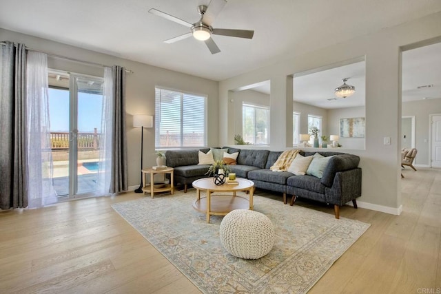 26149 Manzanita St, Murrieta, CA 92563 - living room featuring healthy amount of natural light, light wood-style flooring, ceiling fan, and baseboards