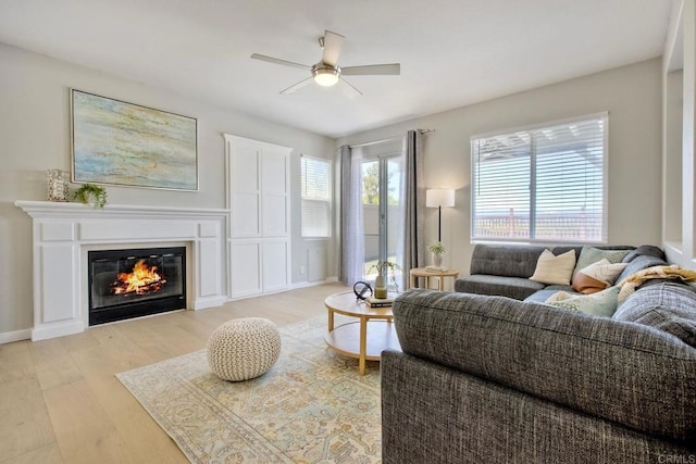 26149 Manzanita St, Murrieta, CA 92563 - living area featuring ceiling fan, light wood-type flooring, and a glass covered fireplace