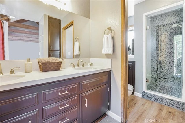 1033 Nadelhorn Dr, Lake Arrowhead, CA 92352 - bathroom featuring a shower stall, double vanity, and wood finished floors