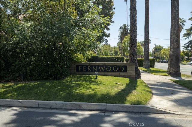 community / neighborhood sign with a lawn