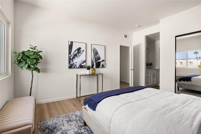 bedroom with wood finished floors and baseboards