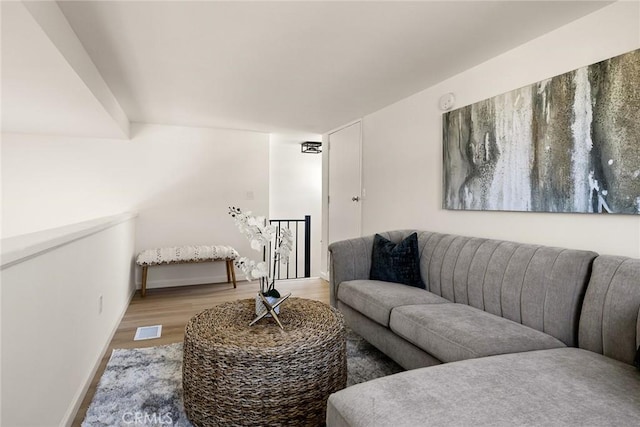 living area with light wood-type flooring and baseboards