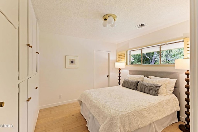 756 Linda Vista Ave, Pasadena, CA 91103 - bedroom featuring light wood-type flooring, a textured ceiling, and baseboards
