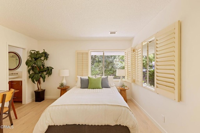 756 Linda Vista Ave, Pasadena, CA 91103 - bedroom featuring light wood-style floors, a textured ceiling, baseboards, and a sink
