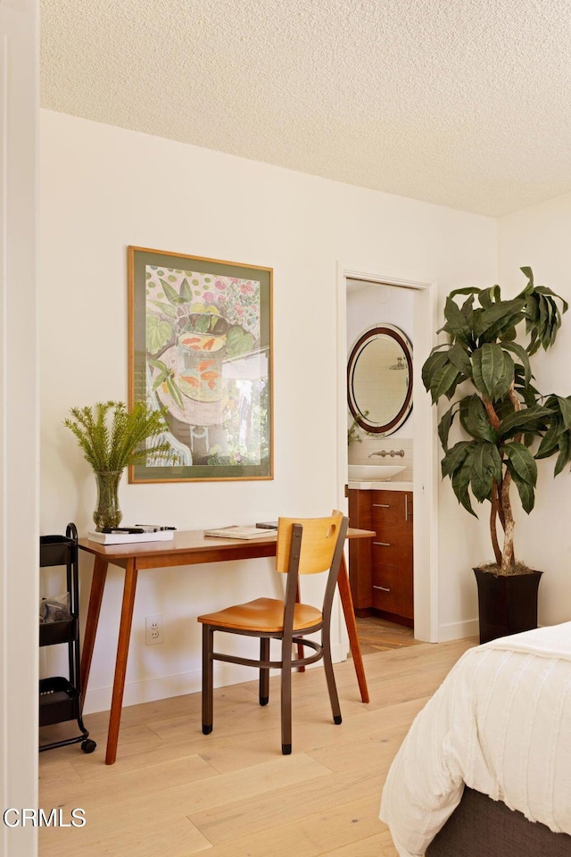 756 Linda Vista Ave, Pasadena, CA 91103 - bedroom featuring light wood finished floors, a textured ceiling, and an office area