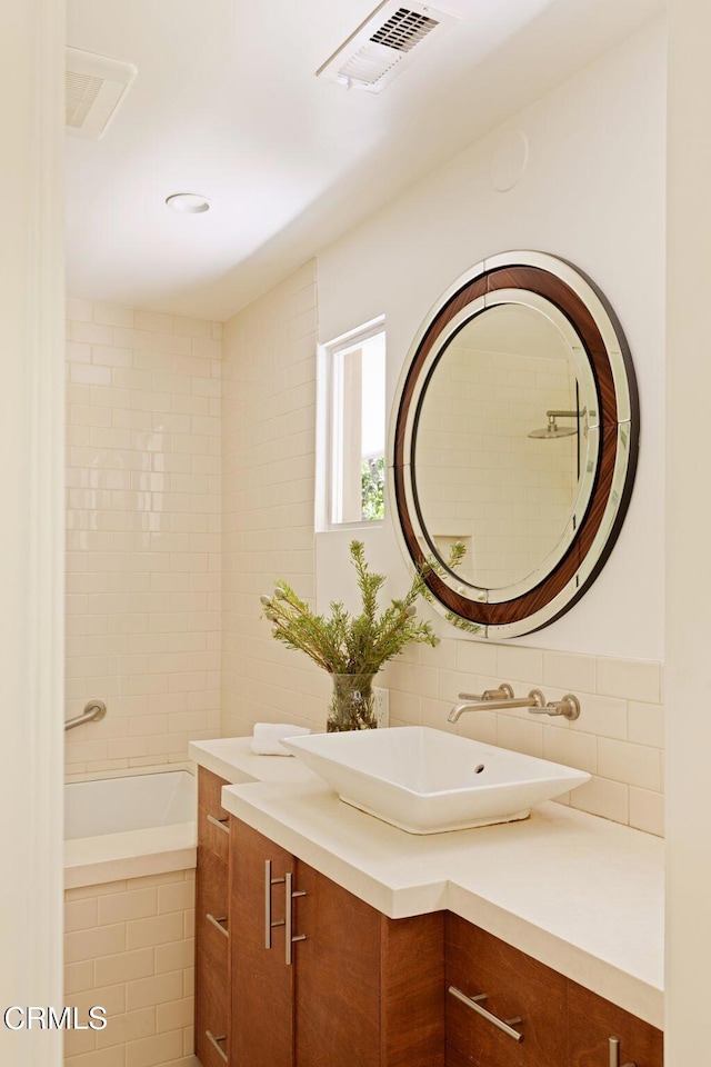 756 Linda Vista Ave, Pasadena, CA 91103 - bathroom featuring vanity, a relaxing tiled tub, and backsplash
