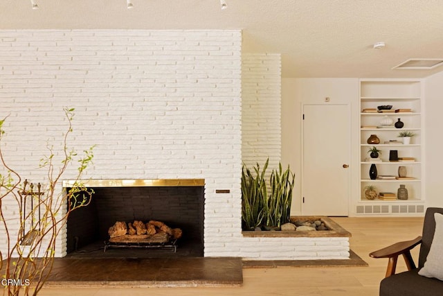 756 Linda Vista Ave, Pasadena, CA 91103 - living area with built in features, wood finished floors, a textured ceiling, and a fireplace