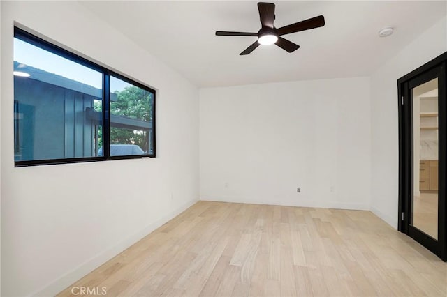 5633 E Deborah St, Long Beach, CA 90815 - empty room featuring wood finished floors, a ceiling fan, baseboards, and a smoke detector