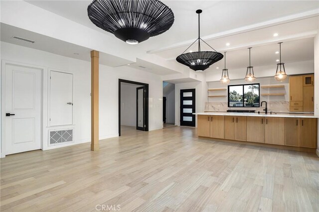 5633 E Deborah St, Long Beach, CA 90815 - kitchen featuring open shelves, light countertops, open floor plan, light wood-type flooring, and a sink