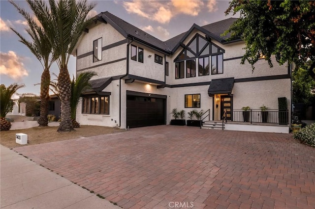 5633 E Deborah St, Long Beach, CA 90815 - tudor-style house featuring a garage, stucco siding, and decorative driveway