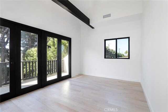 5633 E Deborah St, Long Beach, CA 90815 - empty room featuring wood finished floors, beamed ceiling, baseboards, and high vaulted ceiling