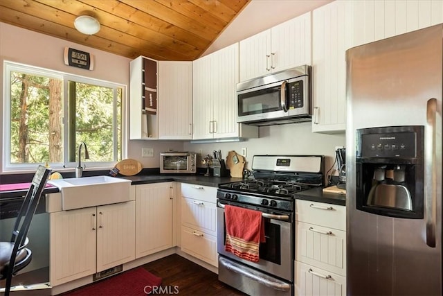 1053 Lausanne Dr, Crestline, CA 92325 - kitchen with appliances with stainless steel finishes, vaulted ceiling, dark countertops, wood ceiling, and dark wood finished floors