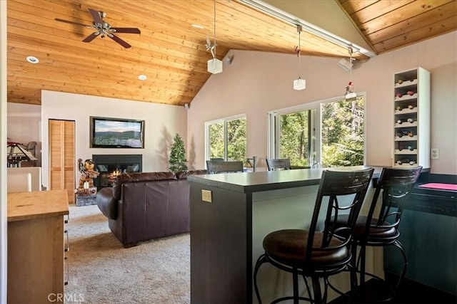 1053 Lausanne Dr, Crestline, CA 92325 - kitchen with wood ceiling, carpet flooring, a kitchen bar, decorative light fixtures, and high vaulted ceiling