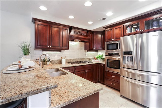 48 Via Athena, Aliso Viejo, CA 92656 - kitchen with stainless steel appliances, a sink, wall chimney range hood, a peninsula, and backsplash