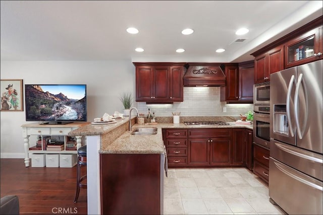 48 Via Athena, Aliso Viejo, CA 92656 - kitchen featuring stainless steel appliances, a sink, dark brown cabinets, a peninsula, and custom exhaust hood