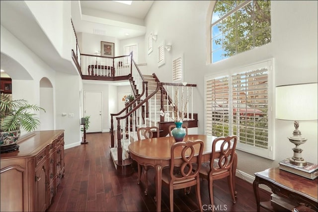 48 Via Athena, Aliso Viejo, CA 92656 - dining room featuring a high ceiling, stairs, dark wood-type flooring, baseboards, and healthy amount of natural light