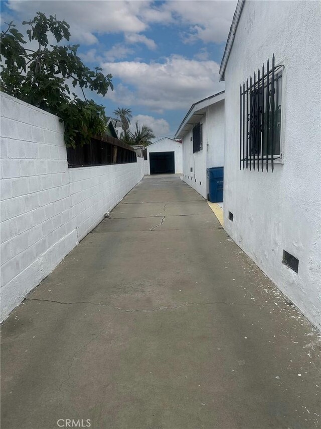 3743 W 112th St, Inglewood, CA 90303 - view of property exterior with crawl space, stucco siding, a detached garage, and concrete driveway