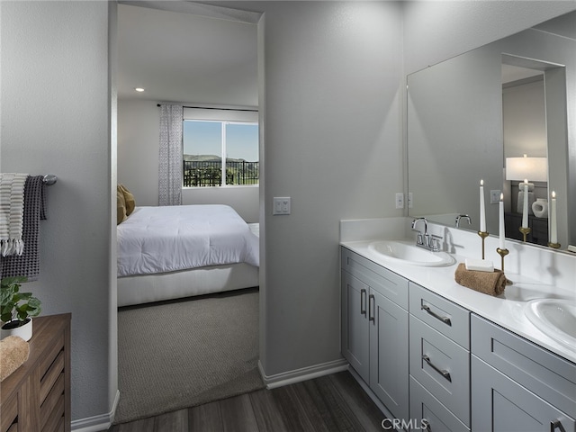 35231 Lopez Ln, Beaumont, CA 92223 - ensuite bathroom featuring wood finished floors, double vanity, and baseboards