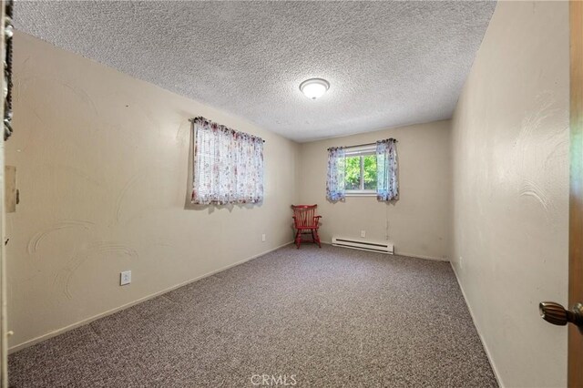 3595 Vista St, Clearlake, CA 95422 - carpeted spare room featuring baseboard heating, a textured ceiling, and baseboards
