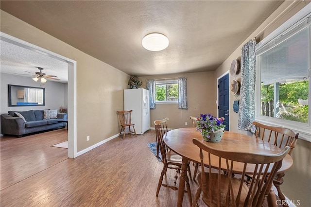 3595 Vista St, Clearlake, CA 95422 - dining space featuring wood finished floors, a textured ceiling, baseboards, and ceiling fan