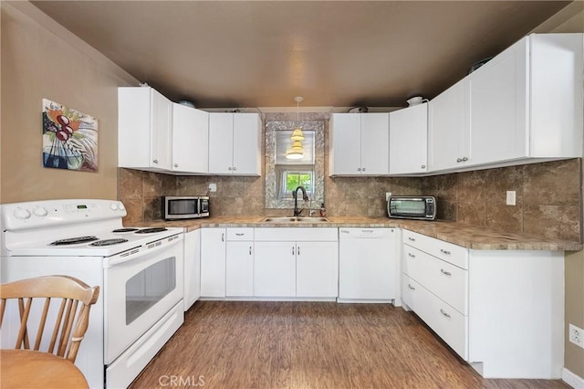 3595 Vista St, Clearlake, CA 95422 - kitchen with white appliances, a sink, wood finished floors, and backsplash