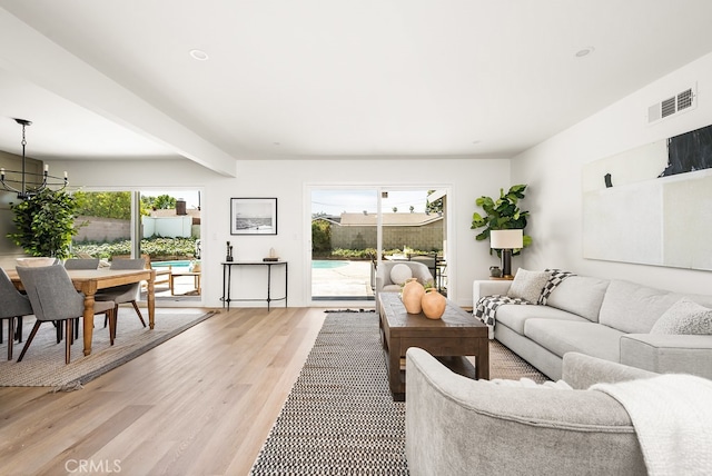 2049 Wickshire Ave, Hacienda Heights, CA 91745 - living room with light wood-type flooring, a chandelier, and plenty of natural light