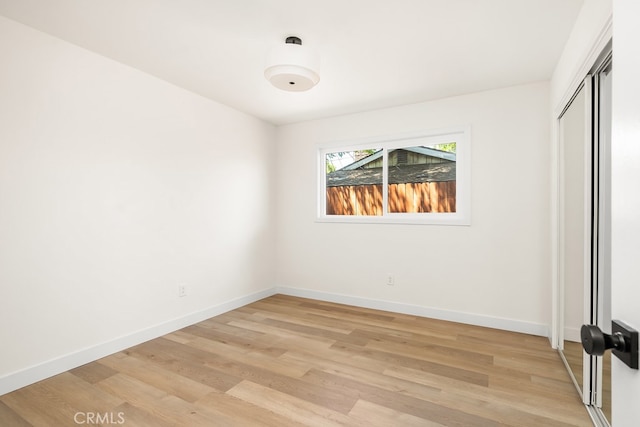 2049 Wickshire Ave, Hacienda Heights, CA 91745 - unfurnished bedroom with light wood-style flooring, baseboards, and a closet