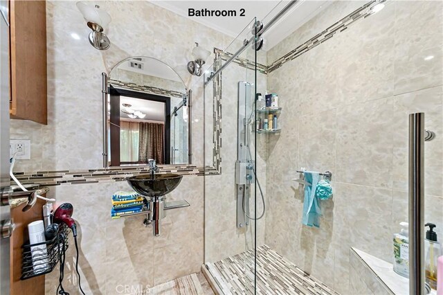 10500 Jordan Ave, Chatsworth, CA 91311 - full bath with a tile shower, ornamental molding, and a sink