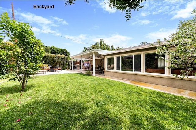 10500 Jordan Ave, Chatsworth, CA 91311 - view of grassy yard featuring ceiling fan and a patio area