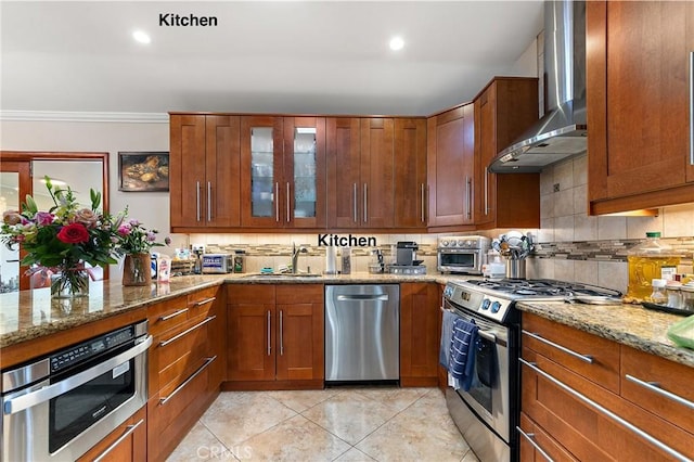 10500 Jordan Ave, Chatsworth, CA 91311 - kitchen with stainless steel appliances, wall chimney range hood, a sink, tasteful backsplash, and light stone counters