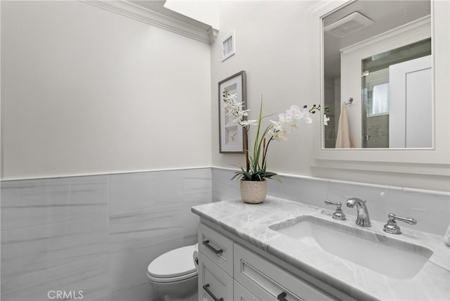 3080 Studio Dr, Cayucos, CA 93430 - bathroom with tile walls, vanity, toilet, crown molding, and wainscoting