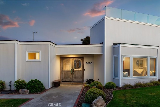 3080 Studio Dr, Cayucos, CA 93430 - exterior entry at dusk featuring a lawn