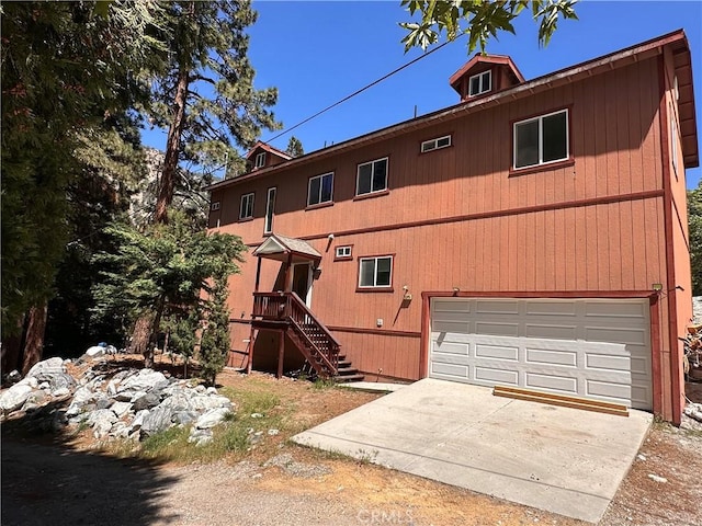 9345 Conifer Dr, Forest Falls, CA 92339 - rear view of house with a garage and concrete driveway