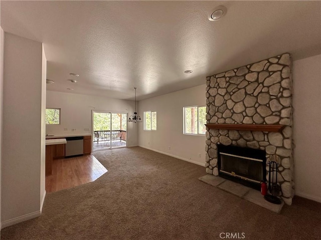 9345 Conifer Dr, Forest Falls, CA 92339 - unfurnished living room featuring light carpet, a fireplace, and a textured ceiling