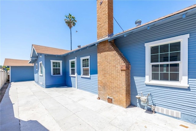 747 W 9th St, San Bernardino, CA 92410 - rear view of house with a chimney, a patio, and fence