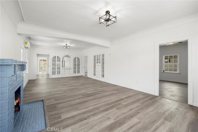 747 W 9th St, San Bernardino, CA 92410 - unfurnished living room featuring wood finished floors, a fireplace, french doors, and baseboards