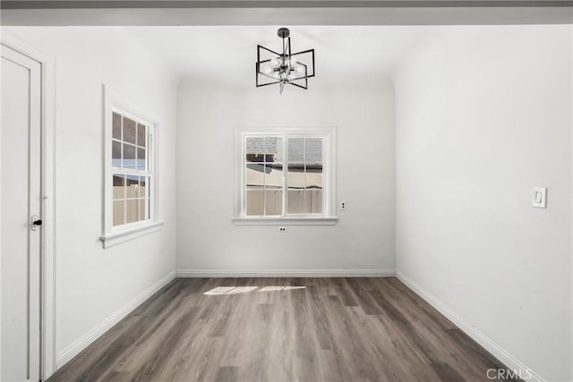 747 W 9th St, San Bernardino, CA 92410 - unfurnished dining area with a chandelier, wood finished floors, and baseboards