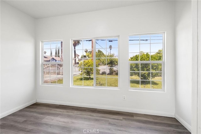 747 W 9th St, San Bernardino, CA 92410 - empty room with healthy amount of natural light, dark wood finished floors, and baseboards
