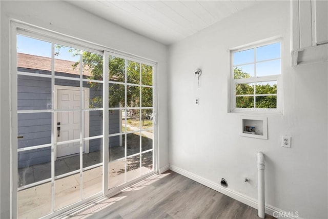 747 W 9th St, San Bernardino, CA 92410 - laundry room featuring washer hookup, healthy amount of natural light, wood finished floors, and baseboards